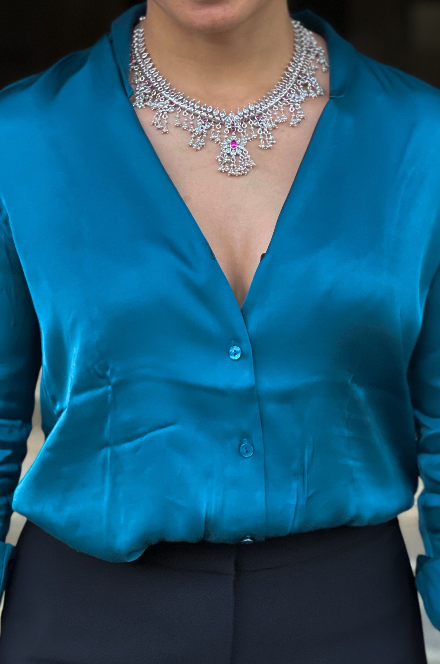 Silver  neckpiece with magenta stones and pearls.