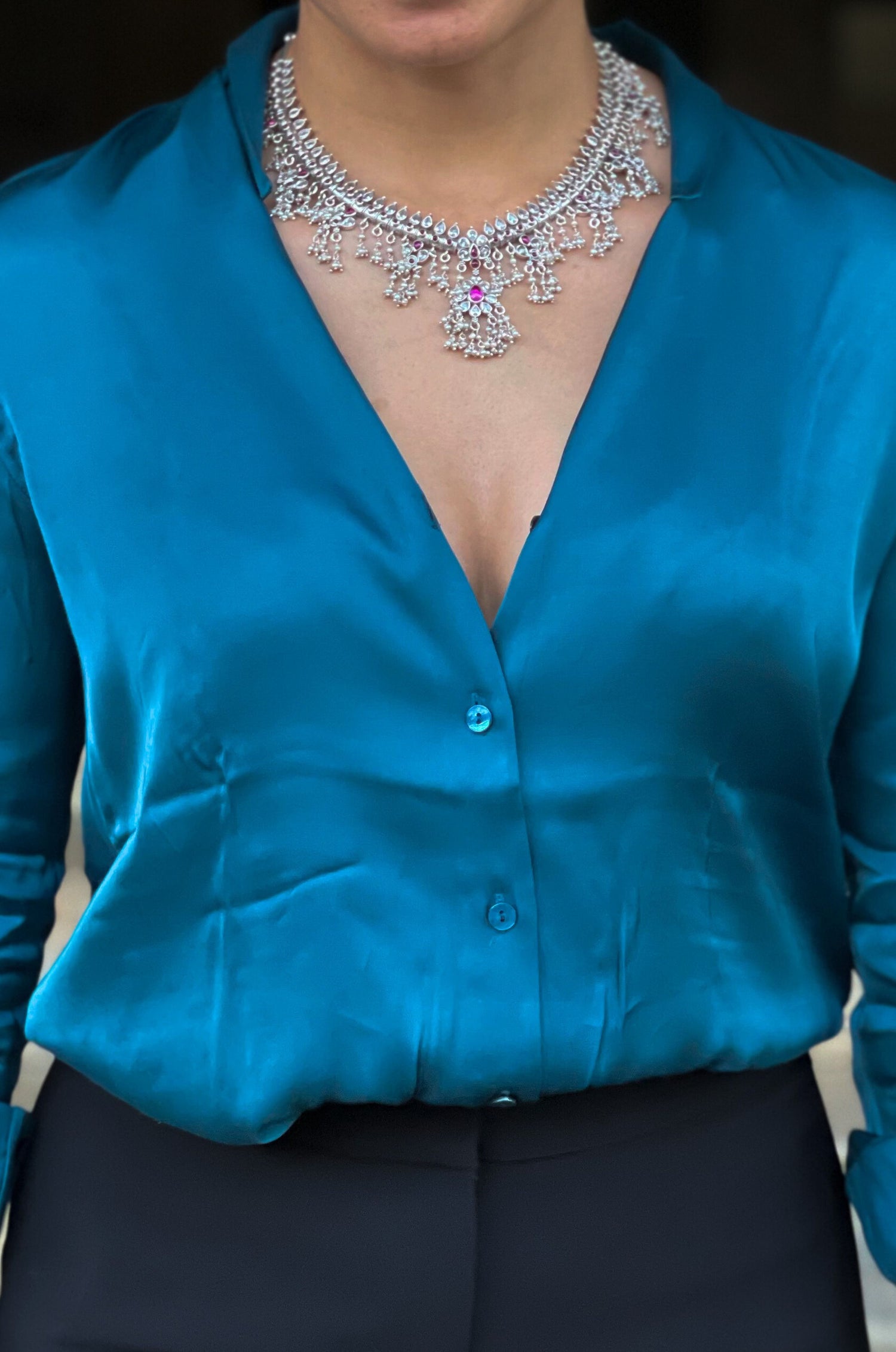 Silver  neckpiece with magenta stones and pearls.
