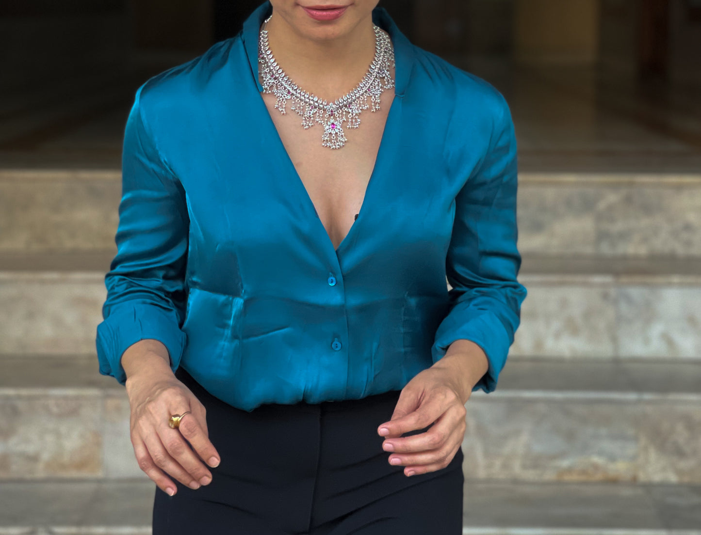 Silver  neckpiece with magenta stones and pearls.