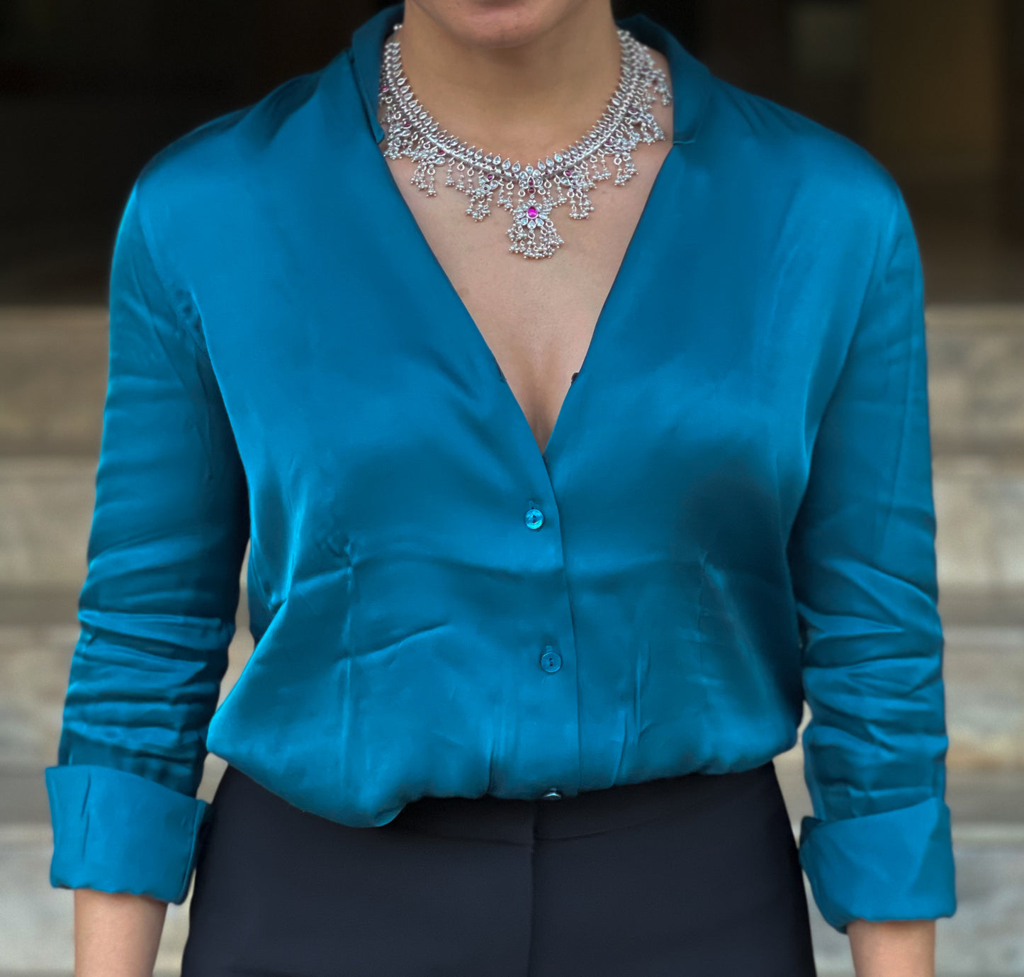 Silver  neckpiece with magenta stones and pearls.