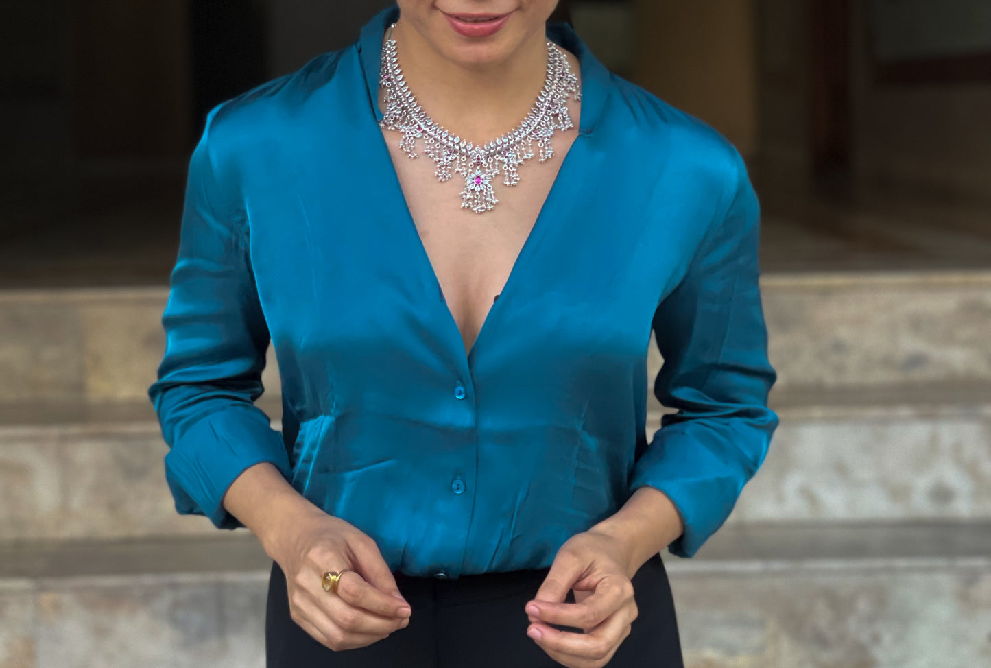 Silver  neckpiece with magenta stones and pearls.